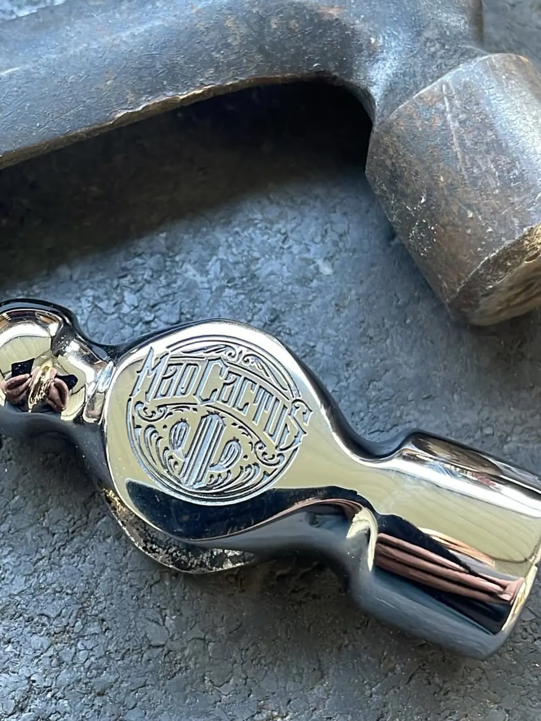 Mad Cactus Customs mark engraved into polished steel